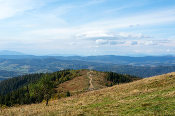 Mountain country road, beautiful cloudy sky. Mount Zakhar Berkut. The Carpathians. Ukraine.