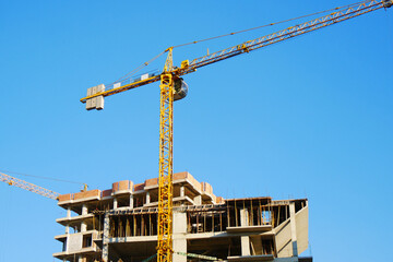 Construction site backgroun.d. Hosting crane near multi-storey building. Industrial background.  96745354