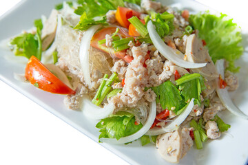 Spicy Glass Noodle Salad with Minced Pork and Vietnamese Sausage on white background.