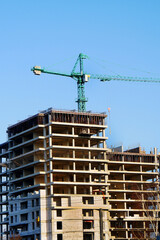 Fototapeta na wymiar Construction site background. Crane near building. Industrial background.