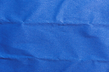 Blue crumpled paper background. Corrugated paper texture.