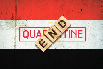 End of quarantine. The inscription on wooden blocks on the background of the flag of Egypt. The end of the pandemic. Business.