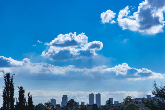 From distance skyscrapers and cloudy birght sky