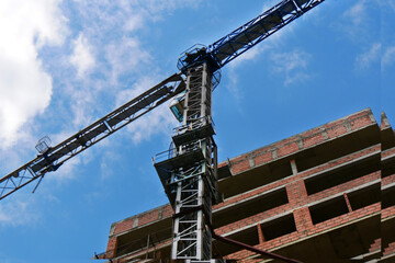 Crane near building. Construction site background.