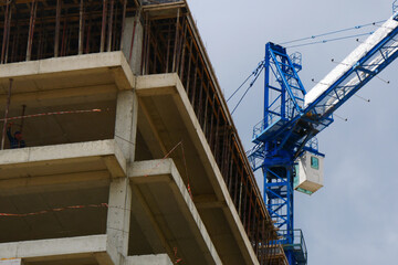Fototapeta na wymiar Crane near building. Construction site background.