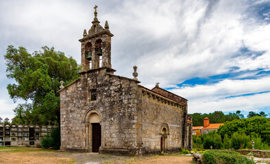 Fototapeta na wymiar View of historic church and cemetery in Porto do Cereixo, a village in the Galicia region of Spain.