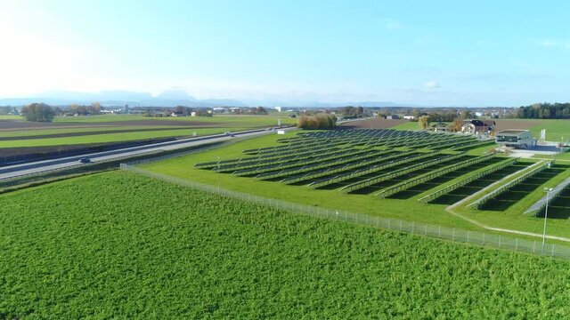 Solar farm with highway and alps in background - multishot