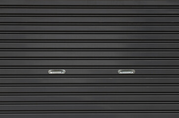 black metal shutter door with silver stainless holder. black steel panel