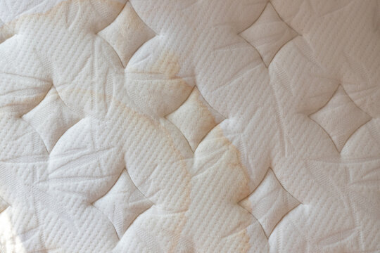 wet bed background and texture. dirty stains from child's pee on mattress. concept : allergies bed need cleaning. top view image.