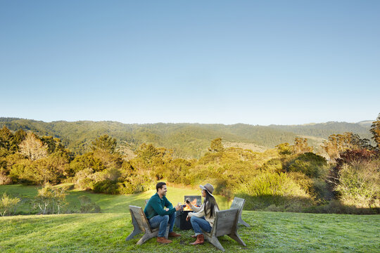 Couple sitting at outdoor fire pit