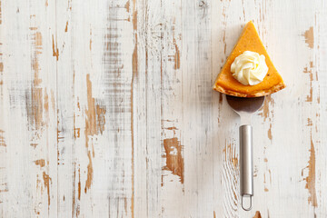 Traditional thanksgiving food concept. Orange delicious homemade pumpkin pie with crust on grunged...