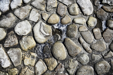 old stone pavement background / abstract pavement, large cobblestones, old road texture