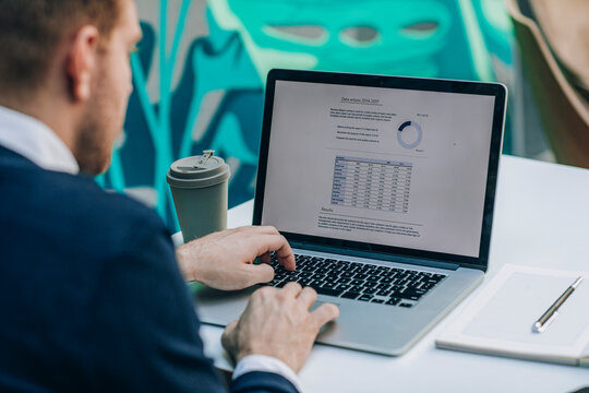 Businessman Doing Chart Report on His Laptop