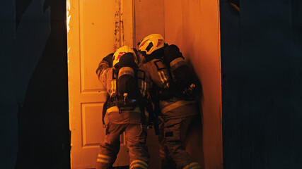 Firefighters breaking into the burning house. High quality photo