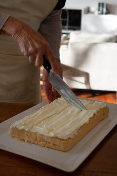 Large cake being cut into small pieces