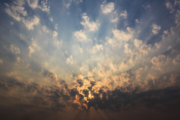 The sky is covered with clouds and the sun's rays penetrate