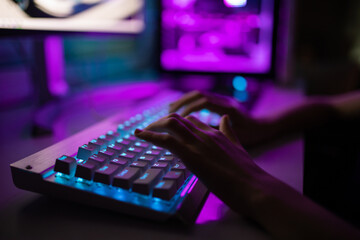 Gamer girl playing on the computer, at home.