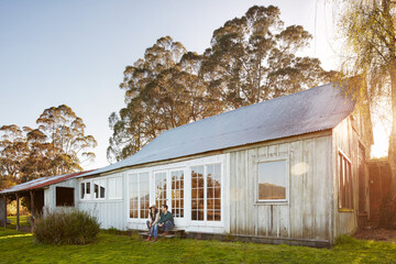 Couple sitting on farmhouse steps