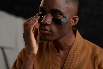 Man using collagen under eye patch