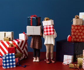 Two Cute Toddler Girls Holding Christmas Presents