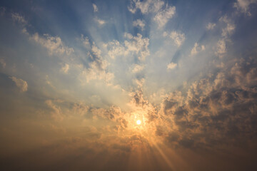 The sky is covered with clouds and the sun's rays penetrate