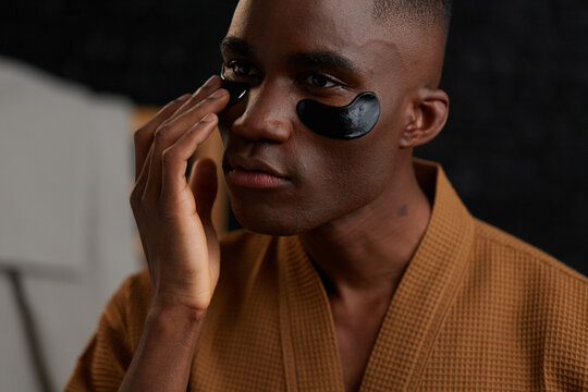 Man using collagen under eye patch