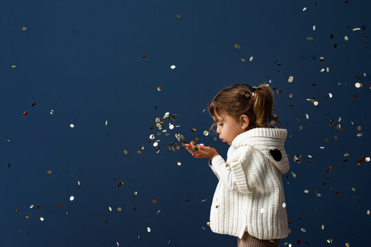 Cute Toddler Girl Playing with Confetti
