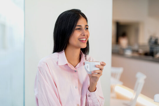 Brunette woman drinking coffee in her morning break