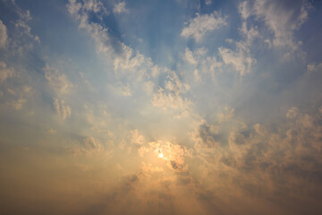 The sky is covered with clouds and the sun's rays penetrate