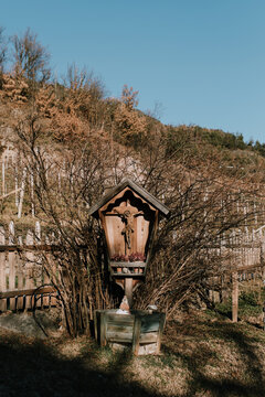 Wooden tabernacle with Jesus on the cross at the mountains in winter