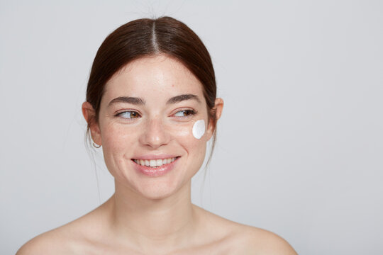 Woman With Lotion In Face Smiling