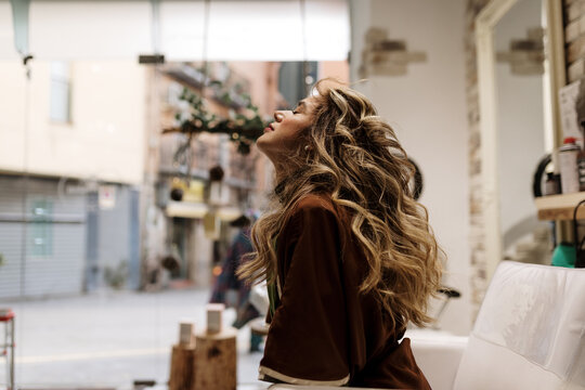 Young Woman Using The Services Of A Hairstyle Saloon.