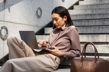 Beautiful Thai Businesswoman Working on her Laptop