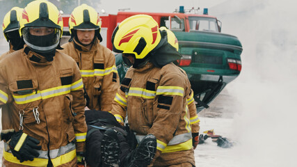 Firefighters carying injured person. Fire drill. High quality photo