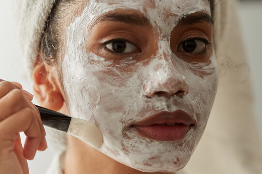 Woman applying face mask