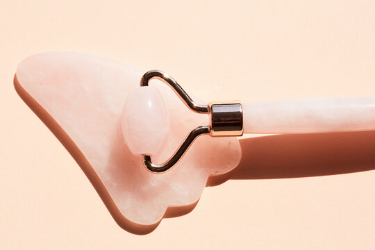 Pink gua sha tool closeup