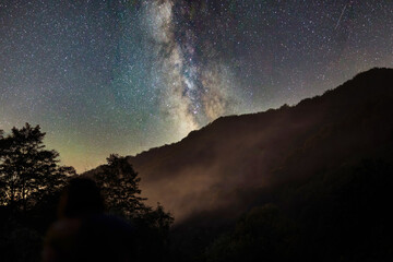 The Milky Way and the Galaxy. Fog under the mountain.