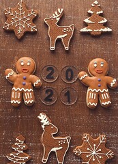 Christmas buscuits glazed sugar for 2021 flatlays. New Year gingerbreads on rustic background top view