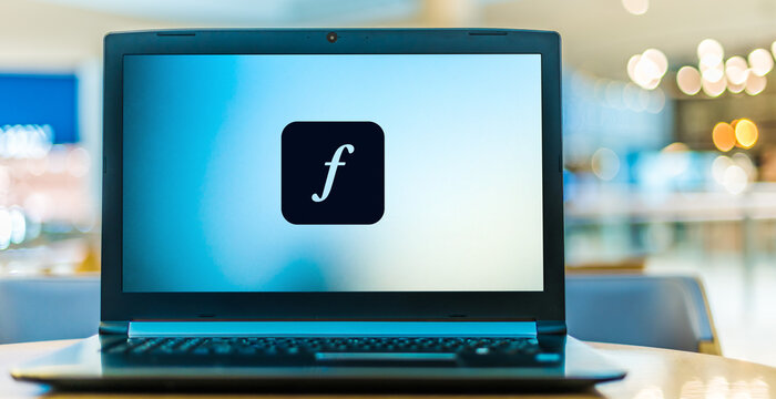 Laptop computer displaying logo of Adobe Fonts