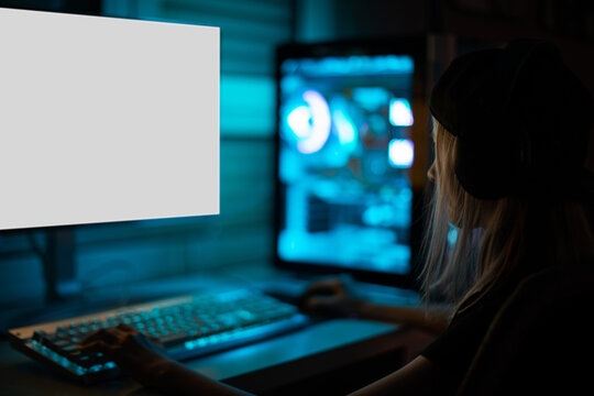 Gamer girl playing on the computer, at home.
