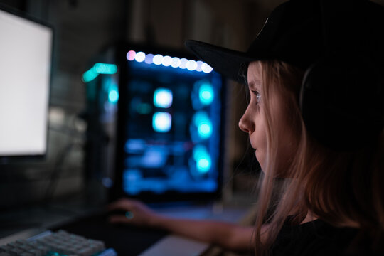 Gamer girl playing on the computer, at home.