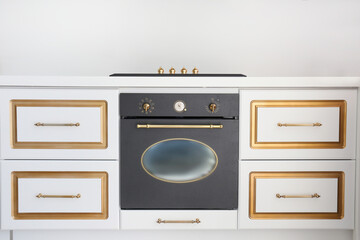 Modern black induction stove with hood. Energy efficient electric hob with built-in oven at home...