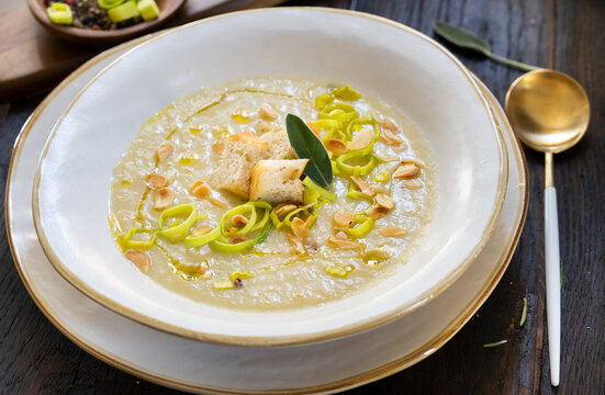 Creamy soup of leek and potatoes with croutons.