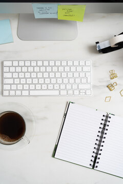 Close Up Of Office Desk With Computer Keyboard And Notebook
