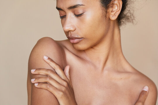 Girl hydrating body with her eyes closed