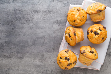 Homemade chocolate muffins on the vintage background.