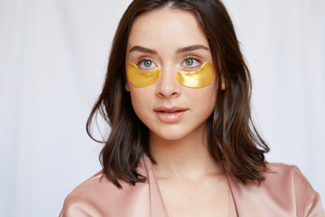 Girl using golden eye patches