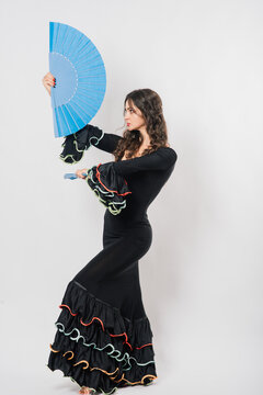 Portrait of beautiful young woman dancing flamenco in studio