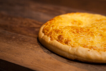 Mini pizza with very much cheese melting