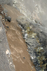 Mutnovsky volcano. Steaming fumaroles on the banks of the mud creek